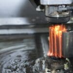 Close up image of a machine metal working with fire coming out