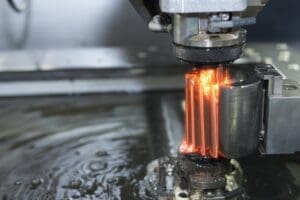 Close up image of a machine metal working with fire coming out