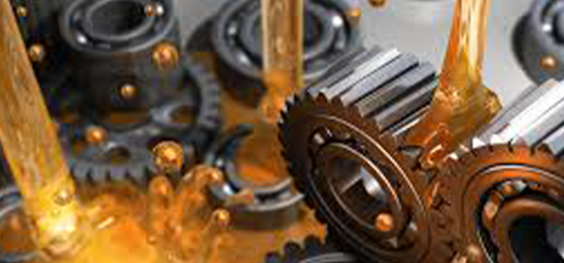 Close-up of gears being lubricated with oil, showcasing ML Lubrication's advanced systems for optimal machinery performance.