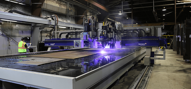 MESSER Cutting Systems CNC machine in operation, performing precision plasma cutting in an industrial metal fabrication facility.