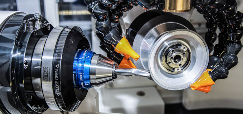 Close-up of a precision tool grinding machine in operation, showcasing advanced tooling and automation from Toolroom Solutions.